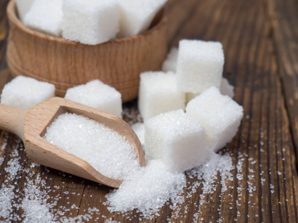 istock Stack of sugar cubes and granulated sugar in a wooden scoop 1397506757