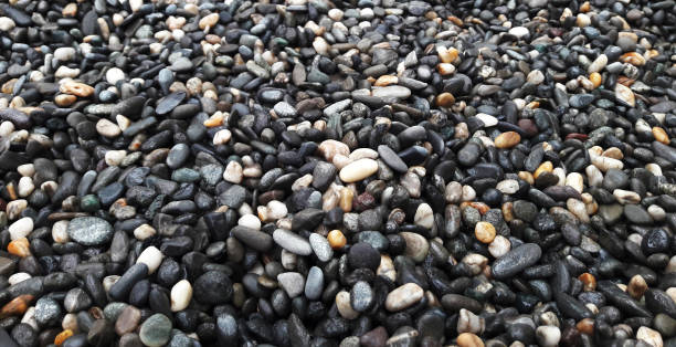 istock boulder pebble beach stones background seamless texture for design use, Naturally rounded gravel at sea shore Nature background texture pattern 1397506842