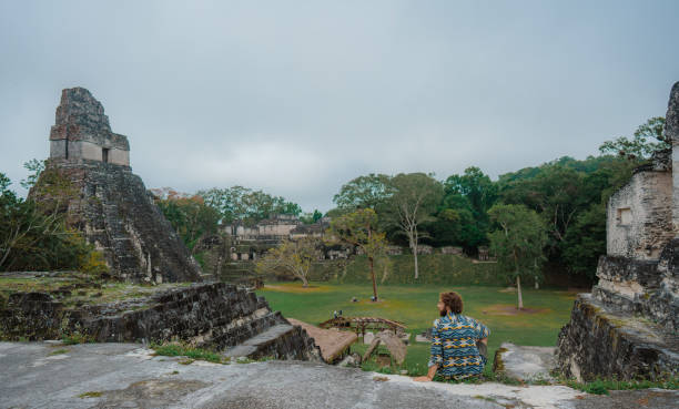 istock Man sitting and looking at   Tikal National Park 1397507440