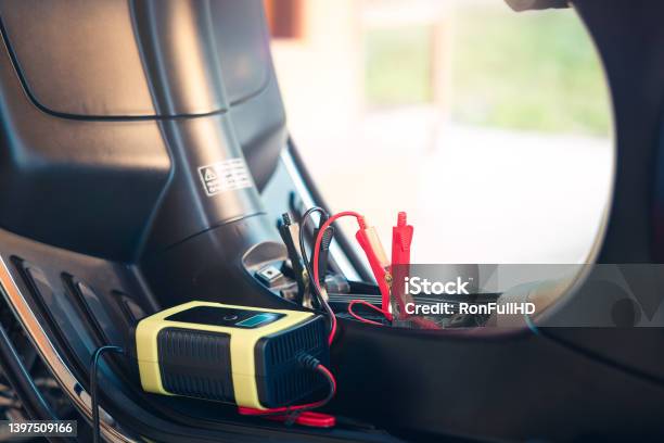 Charging Battery And Repair For Start Motorcycle Or Motorbike Stock Photo - Download Image Now