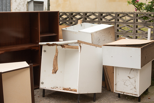 Old furniture in bad condition at the outside of a house