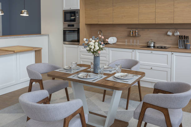 istock dinnig and kitchen area in minimalist modern interior design huge bright apartment with an open plan in Scandinavian style in white, blue and dark blue colors with columns in the center 1397509472