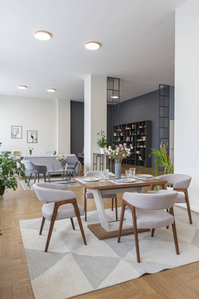 istock dinnig and kitchen area in minimalist modern interior design huge bright apartment with an open plan in Scandinavian style in white, blue and dark blue colors with columns in the center 1397510314