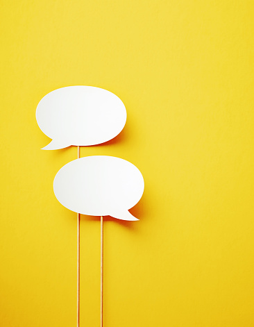 Two Blue Speech Bubble Shapes on Flat Yellow Background with Shadow 3D Illustration