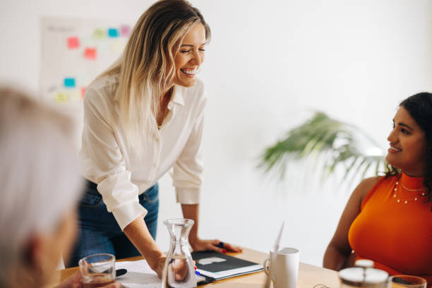 istock Cheerful businesswoman brainstorming with her team 1397510370