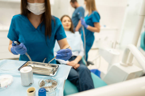 istock Unrecognizable female dental assistant, preparing and adjusting dental drill 1397510599