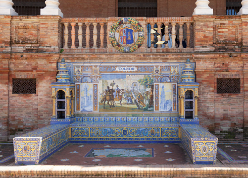 Seville, Spain - 7th April 2022 Tiled alcove and bench representing the Spanish province of Toledo in the Plaza de España in central Seville, Andalucia, Spain.