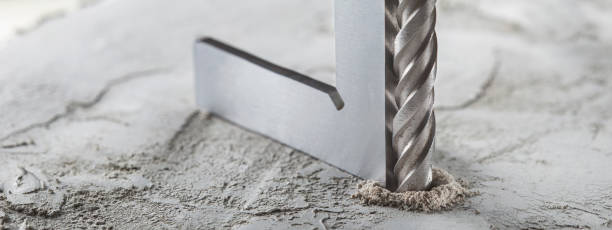 istock drill bit make holes in concrete wall with steel triangle. Building work industry. 1397511439