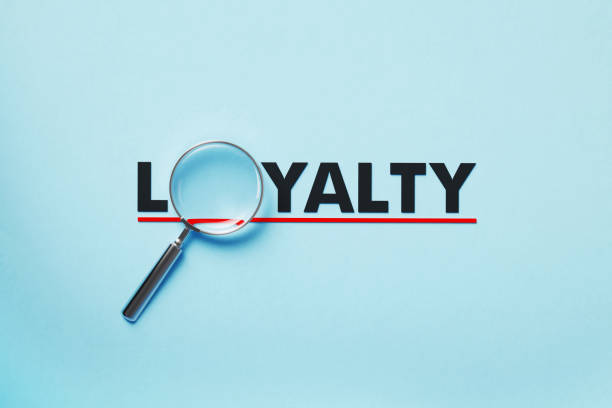 istock Magnifier Forming Loyalty Word On Blue Background 1397511527