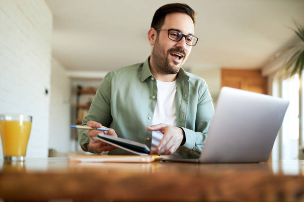 istock Happy businessman working on a computer at home. 1397512165
