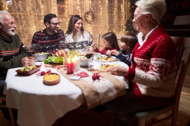 istock Happy extended family talking during Christmas dinner at home. 1397512837