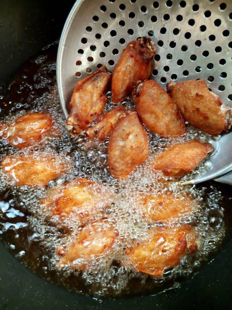 istock Cooking Fried Chicken in pan - food preparation. 1397512961