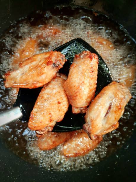 istock Cooking Fried Chicken in pan - food preparation. 1397512972