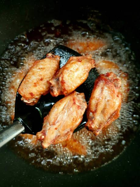 istock Cooking Fried Chicken in pan - food preparation. 1397512975