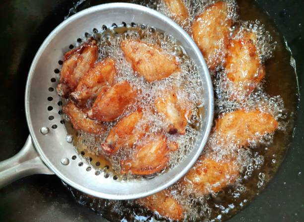 istock Cooking Fried Chicken in pan - food preparation. 1397512979