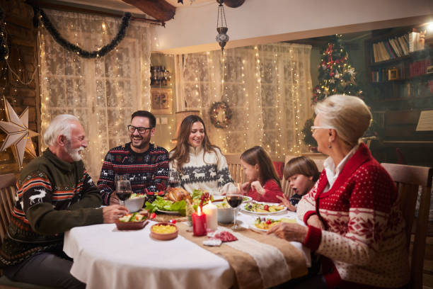 istock Happy multi-generation family taking during Christmas meal at dining table. 1397513416