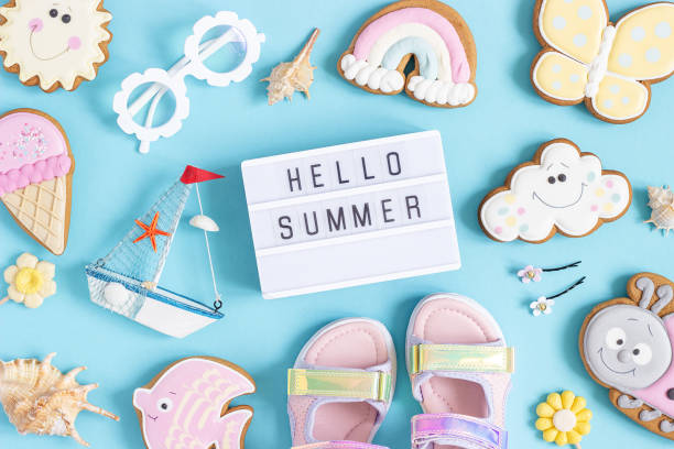 istock Hello summer text on lightbox and cute summer symbols on blue background. Top view, Flat lay. Creative summer concept, greeting card 1397514039