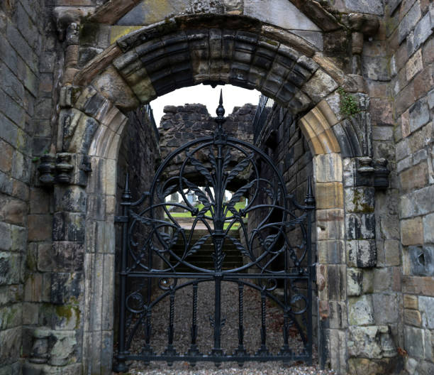 istock Old Gate in a Medieval Ruined Cemetery Entrance 1397515422