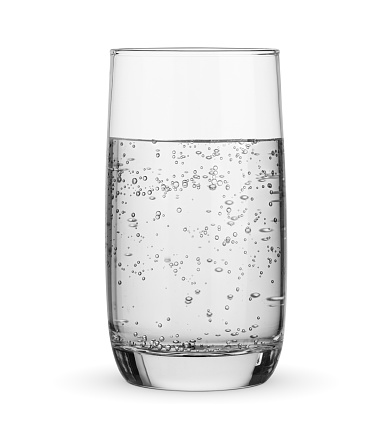 Glass of pure drinking carbonated sparkling water isolated on white background.