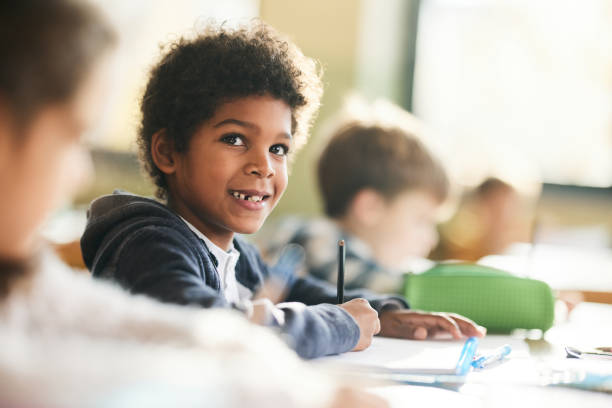 istock African American schoolboy writing a dictation during a class in elementary school. 1397515800