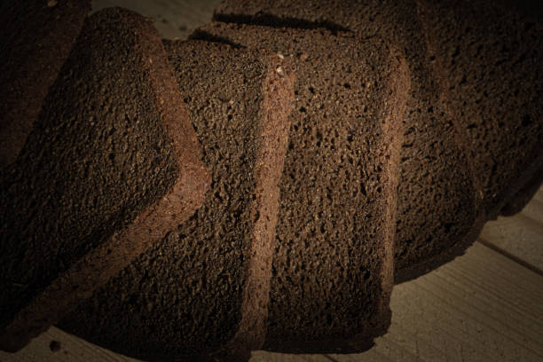 Pieces of black bread on a wooden table. High quality photo