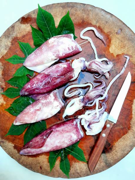 istock Cutting and Slicing Squid on cutting board - food preparation. 1397517200