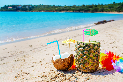 Coconut and pineapple drinks on the beach in summer