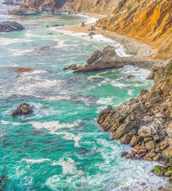Rocks and sand in world famous Big Sur State park coast. Central California, USA