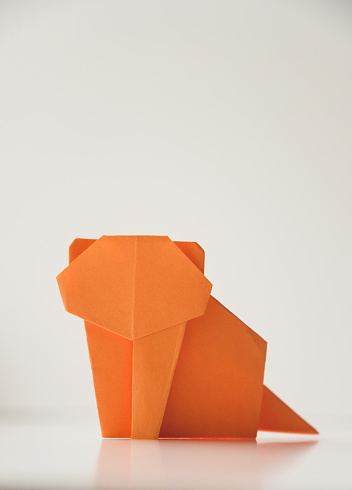 Close up of Origami tiger folded from an orange colour paper