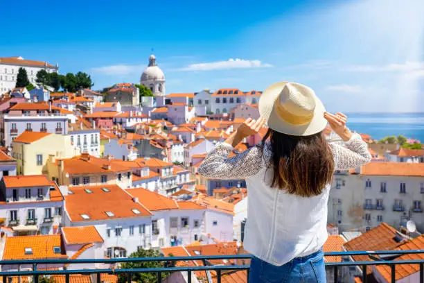 Photo of A tourist woman looks at the beautiful cityscape of Lisbon