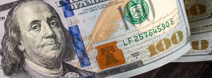 US $100 bills close-up. Shallow depth of field.
