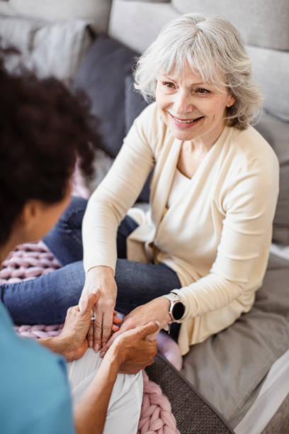 District nurse visiting a patient at home stock photo