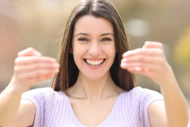 Happy teen saying come here at camera in a park