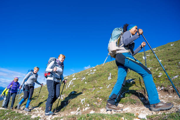 istock Female hikers walking on mountain trail 1397527151
