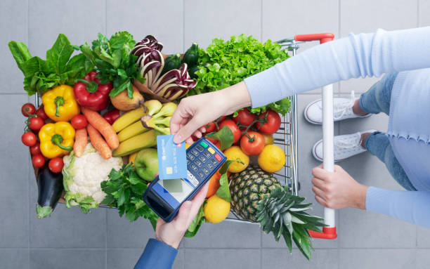 istock Woman paying for groceries using a credit card 1397527340