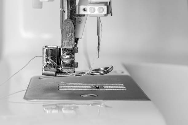 istock Part of the sewing machine close-up - foot, needle and thread. Monochrome image 1397529222