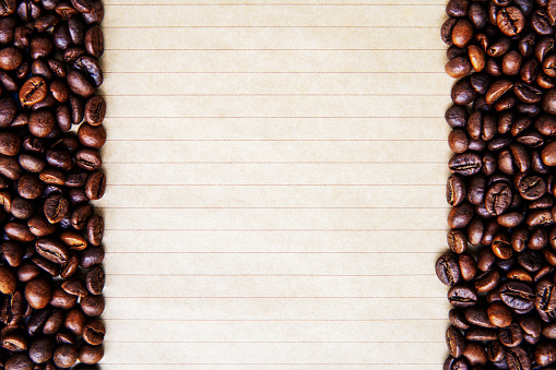 Coffee beans frame on lined paper background