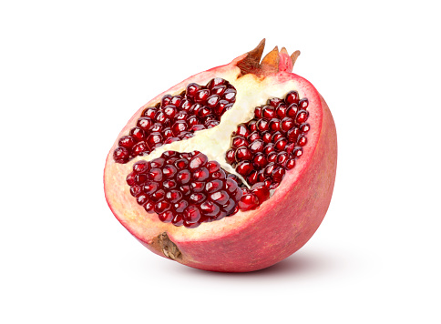 Fresh ripe pomegranate half sliced isolated on white background with clipping path.