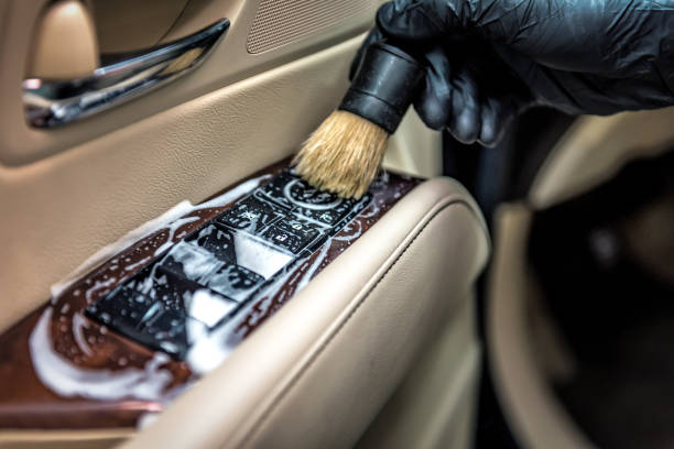 Specialist cleaning car parts with a brush and foam. Car detailing stock photo