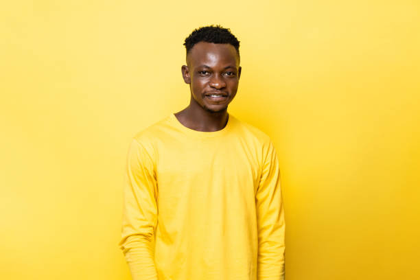 istock Young African man smiling on isolated yellow stuido background 1397537200