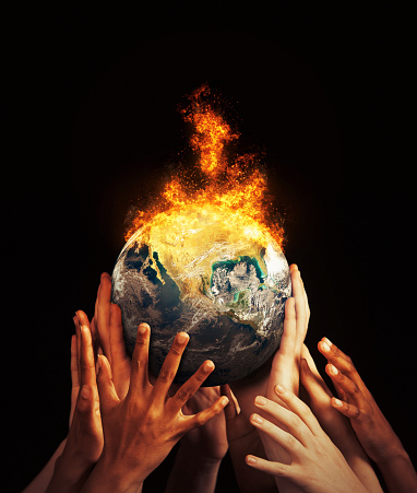 Group of diverse hands supports a world that has burst into flames.\n\nPublic domain Earth image from https://www.nasa.gov/multimedia/imagegallery/image_feature_2159.html