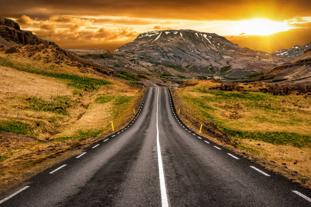 Asphalt road in the mountains in Iceland stock photo