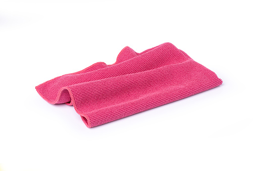 Closeup pink microfiber cloth isolated on white background with clipping path.