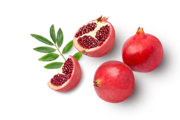 istock pomegranate fruit with green leaf isolated on white 1397537277