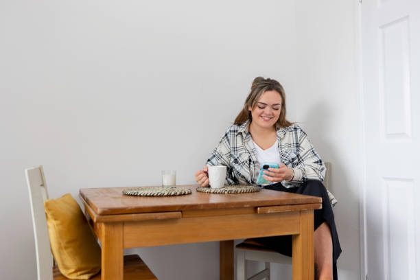 istock Laughing at Her Phone whilst Having a Coffee 1397538048