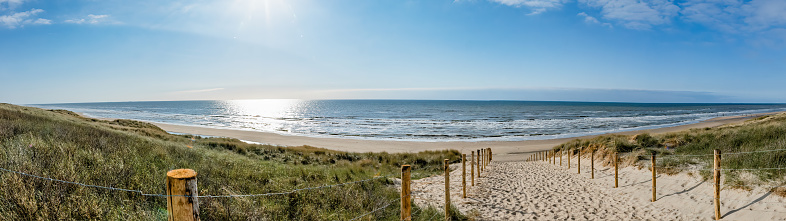 Wooden boardwalk over sand dunes at the coast of island Sylt, German North Sea Region