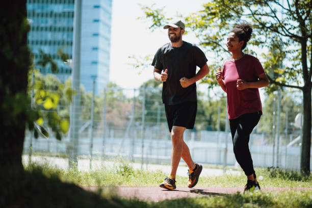 istock Multi ethnic man and woman jogging and exercising outdoors on sunny day 1397541408