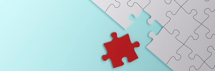 3D Gold and white jigsaw puzzle pieces on a white background. Horizontal composition with copy space.