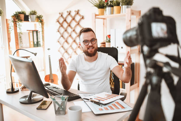 istock Handsome Bearded Male Explaining Stock Market While Being Recorded 1397544210
