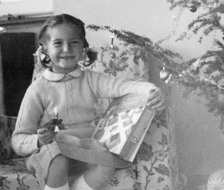 Vintage photo of a little girl holding a doll. USSR, circa 1945. Retro.